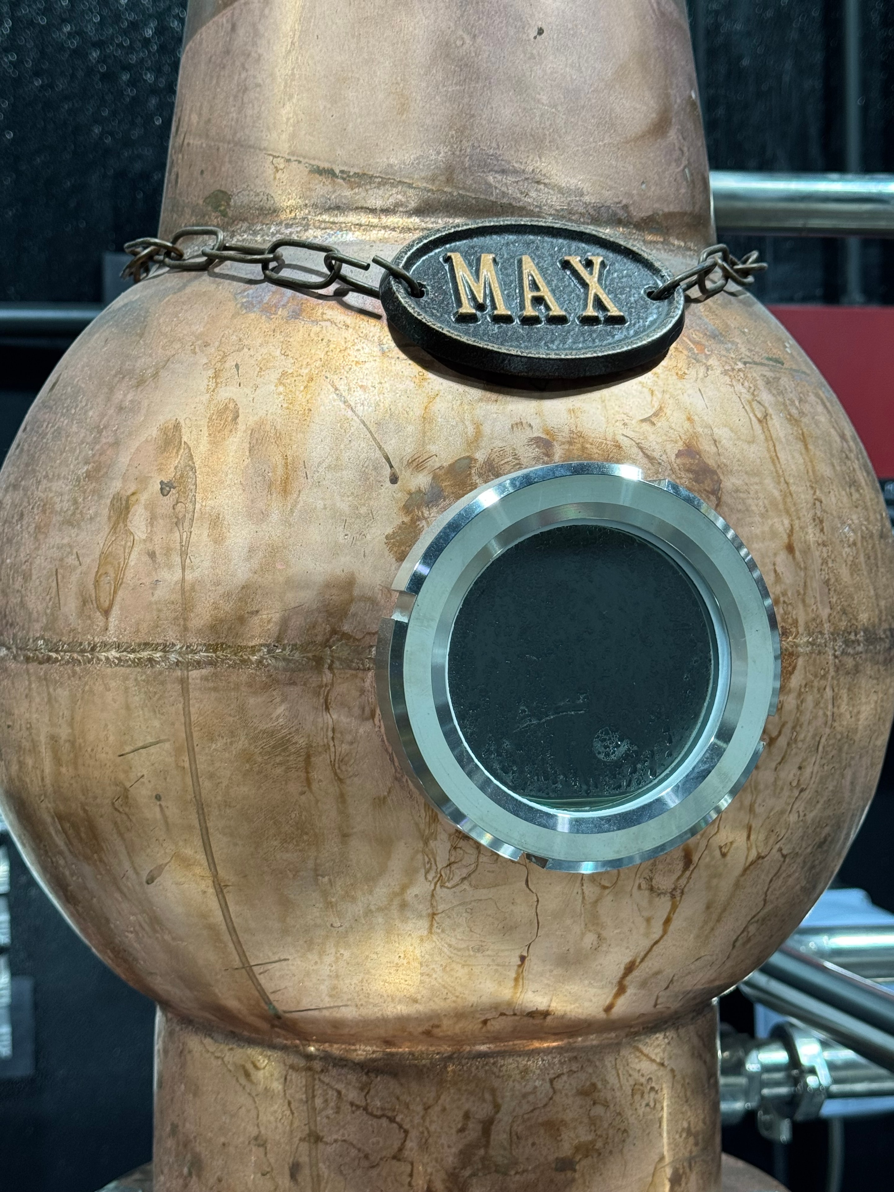 Close-up of the copper onion dome with its MAX level plaque and porthole window