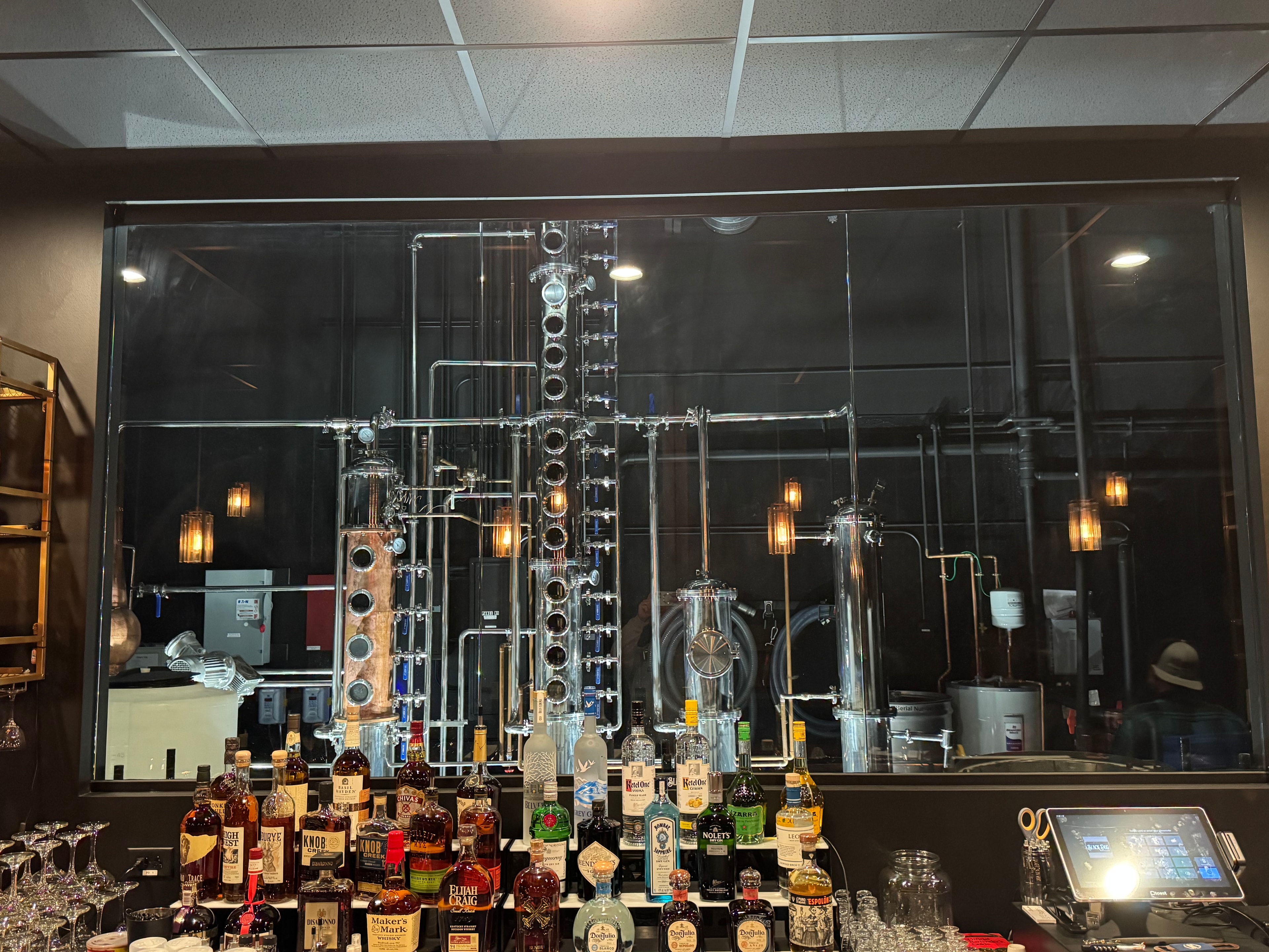 The stills visible through the glass behind the lounge bar